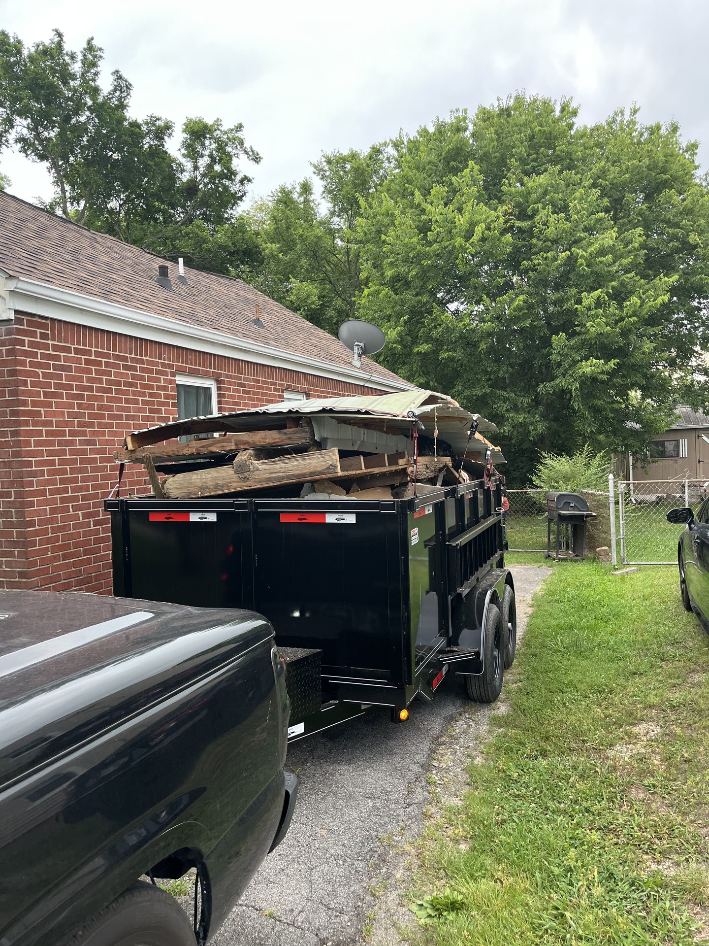 Junk Magician dump trailer loaded with debris at a Nashville home